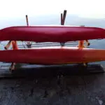 Kayaks on cedar rack by the water